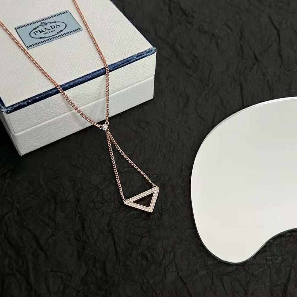 Full length of Prada Women Eternal Gold Cut-out Pendant Necklace on display