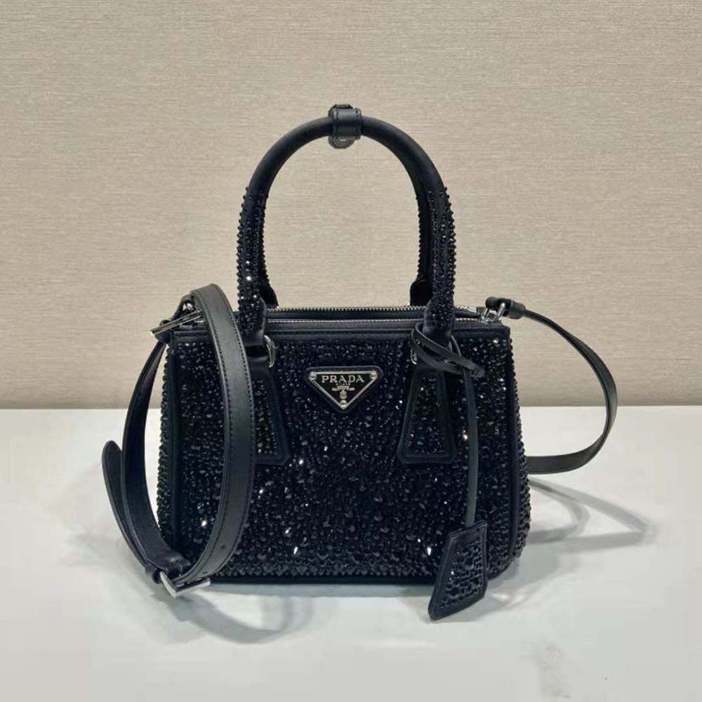 Close-up of crystal embellishments and satin texture on Prada mini-bag