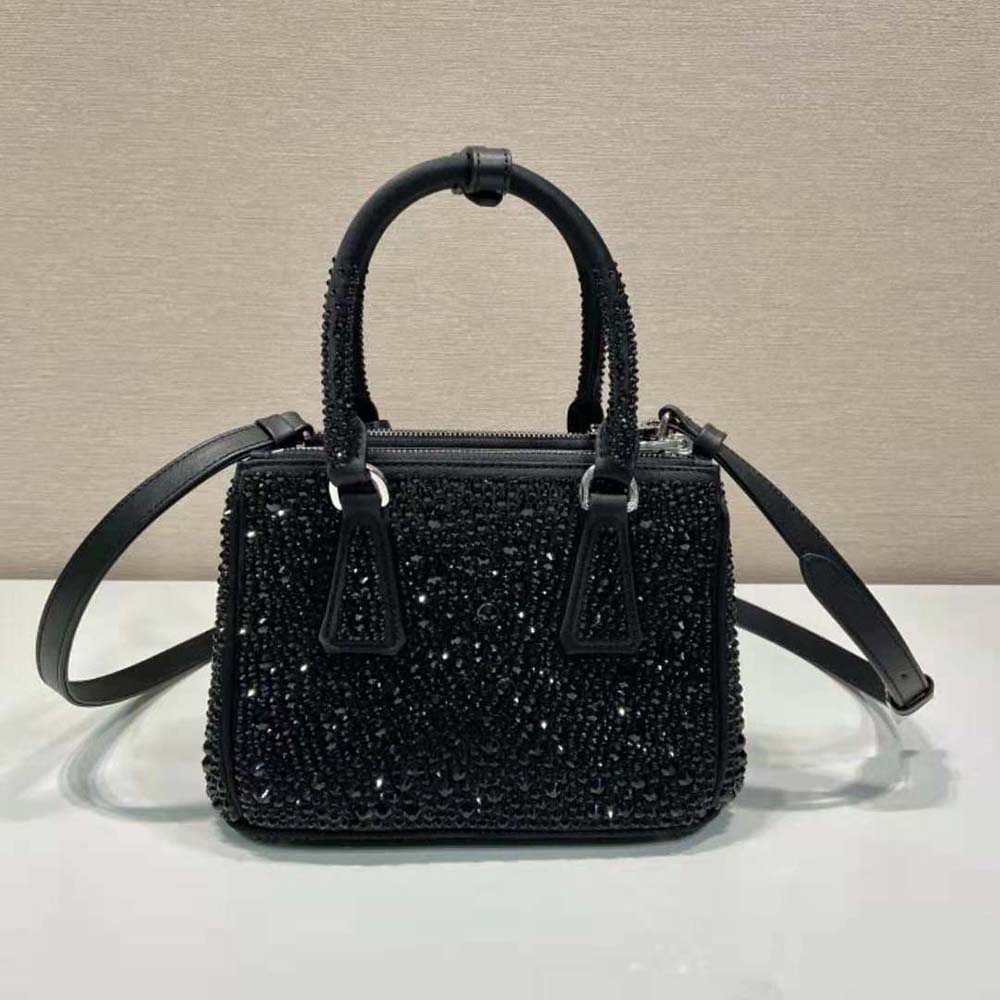 Side angle showing silver hardware and flap closure on Prada mini-bag