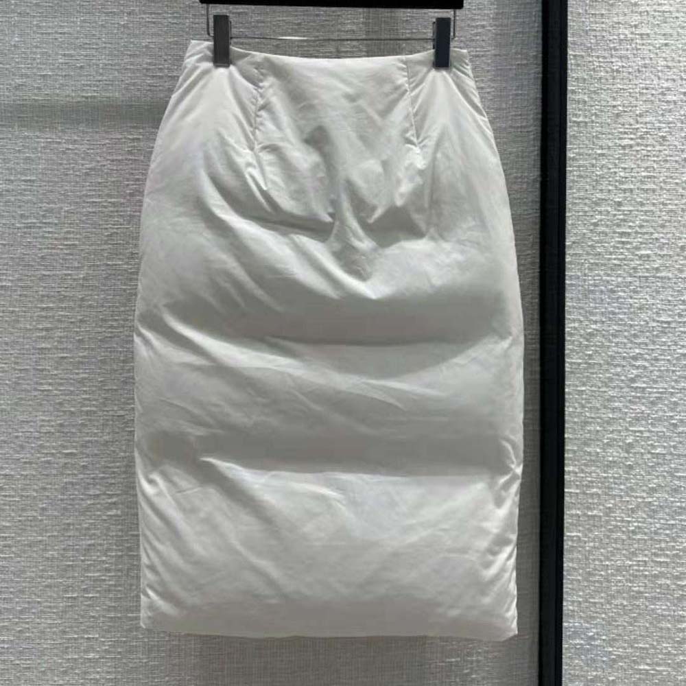 Close-up of Prada triangle logo detail on white padded cotton skirt