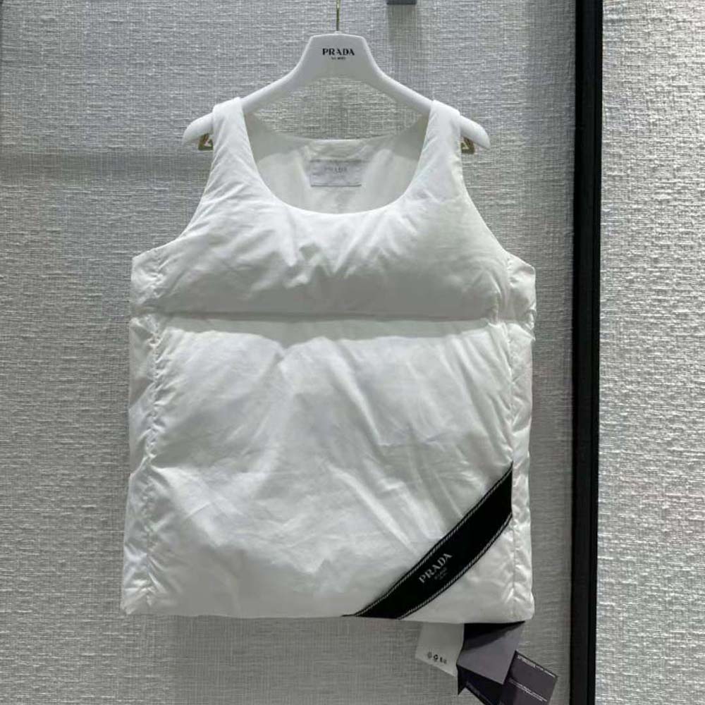 Close-up detail of Prada embossed tab on padded cotton top in white