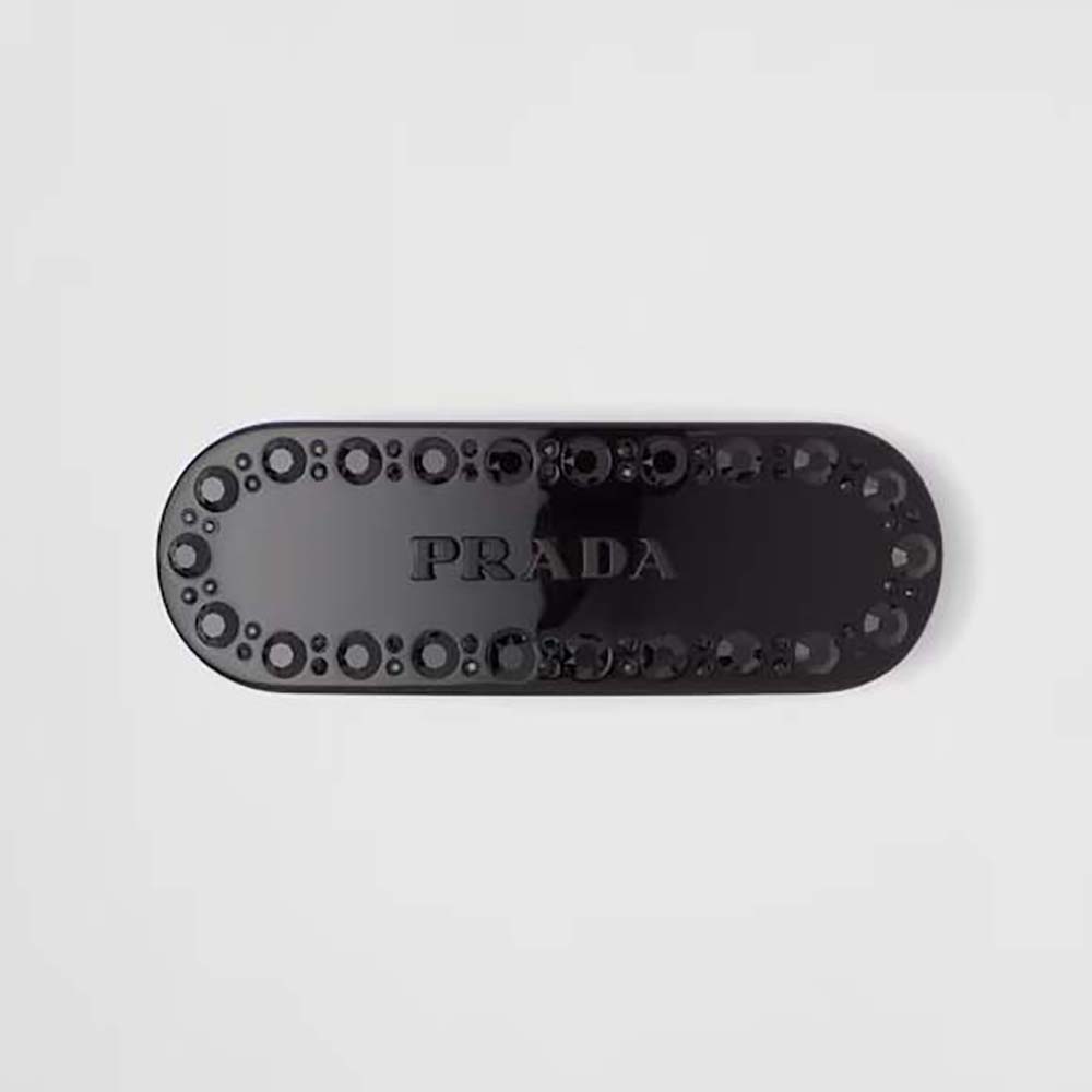 Close-up of Prada Women Plex Hair Clip glossy black surface