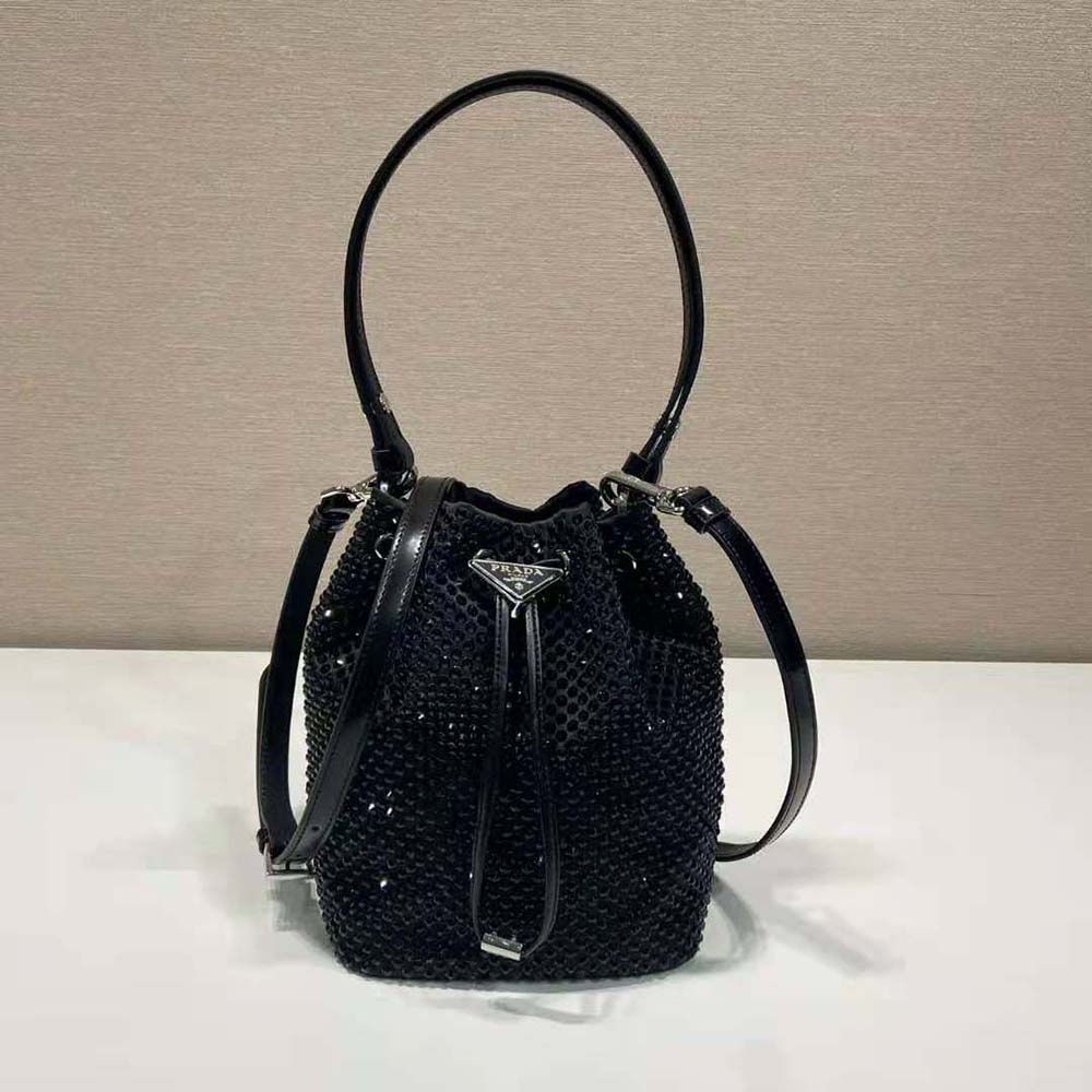 Close-up of black satin texture and silver crystal hardware on Prada mini-bag