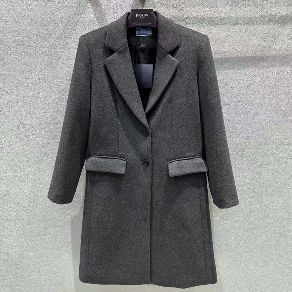 Close-up of signature Prada buttons on velour coat sleeve