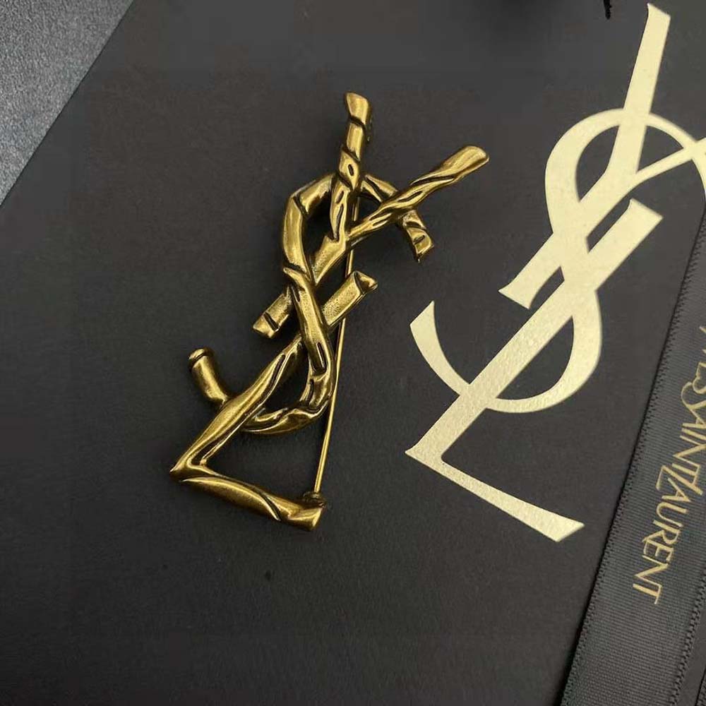Full view of Saint Laurent YSL Women Opyum YSL Crocodile Brooch on black fabric