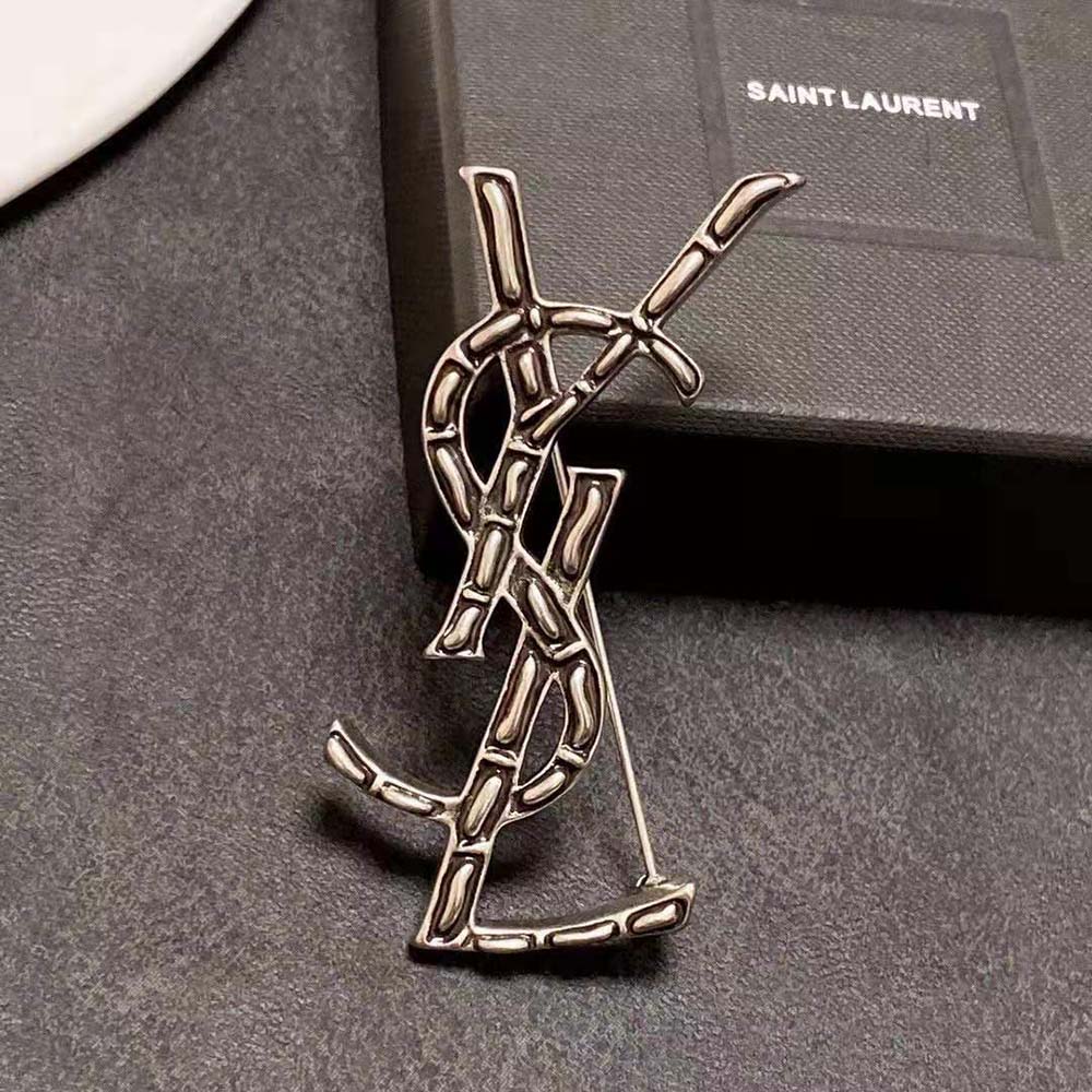 Saint Laurent YSL Women Opyum YSL Crocodile Brooch pinned on black blazer lapel