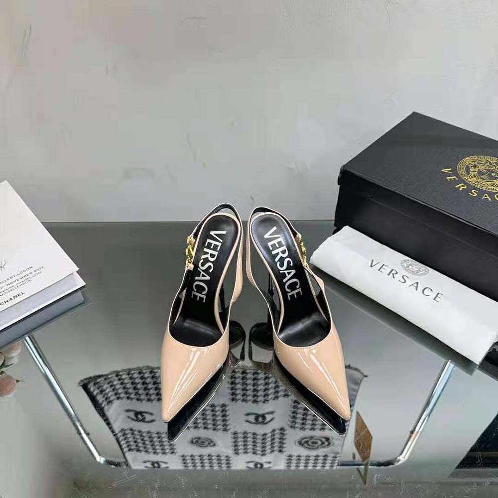 Close-up of gold Medusa emblem on pink Versace Women Medusa ’95 Pumps
