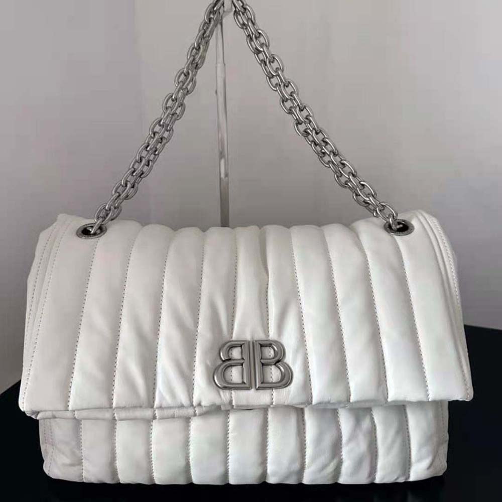 Close-up of gold chain strap and quilted leather detail