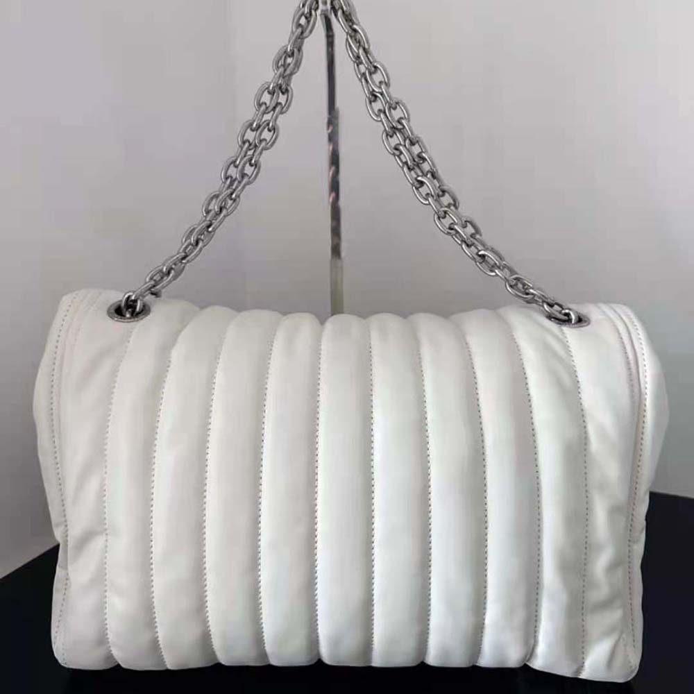 Side profile highlighting medium size and smooth off white leather