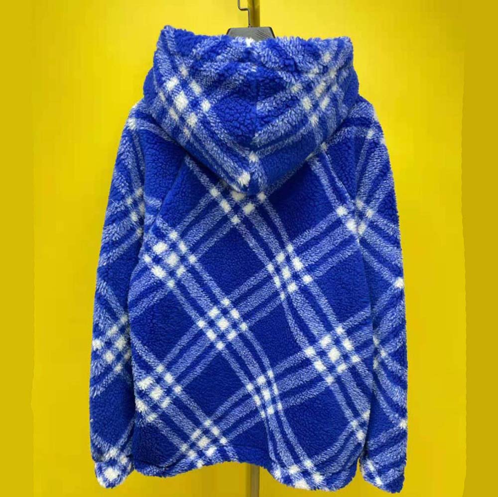 Close-up of Burberry check lining inside the blue fleece hoodie hood