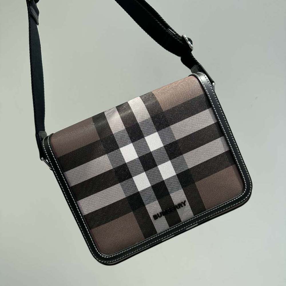 Close-up of brown leather and gold hardware on Burberry Men Small Alfred Messenger Bag-Brown