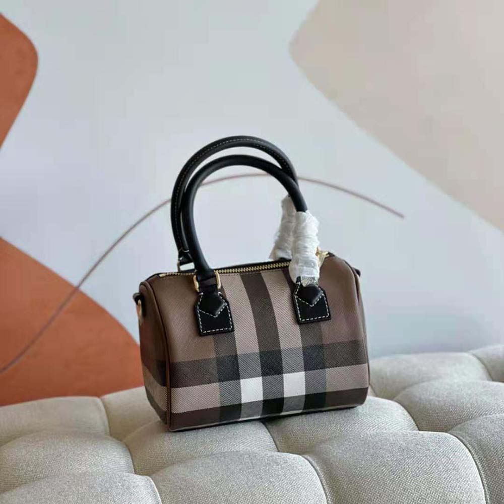 Side angle of Burberry Women Mini Check Bowling Bag-Black with adjustable shoulder strap