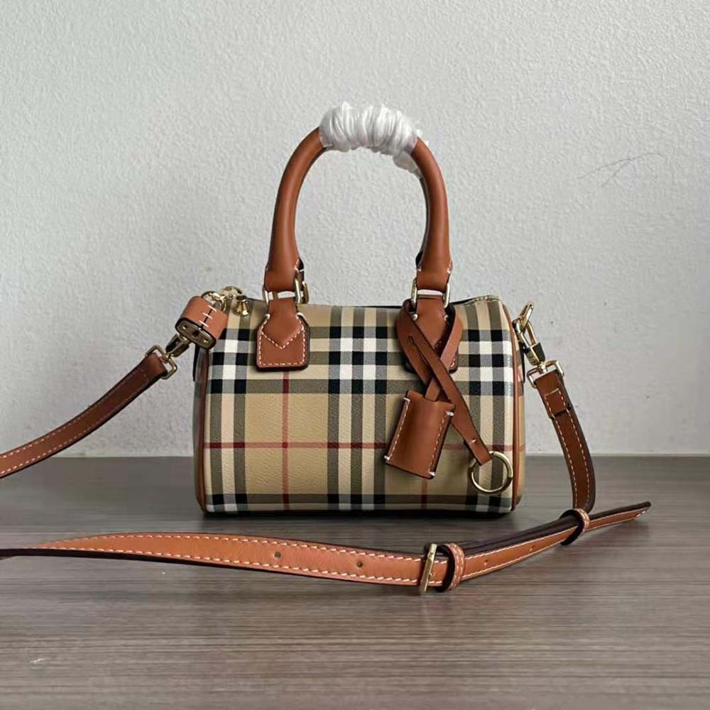 Close-up of gold-tone hardware and leather trim on Burberry Women Mini Check Bowling Bag-Brown