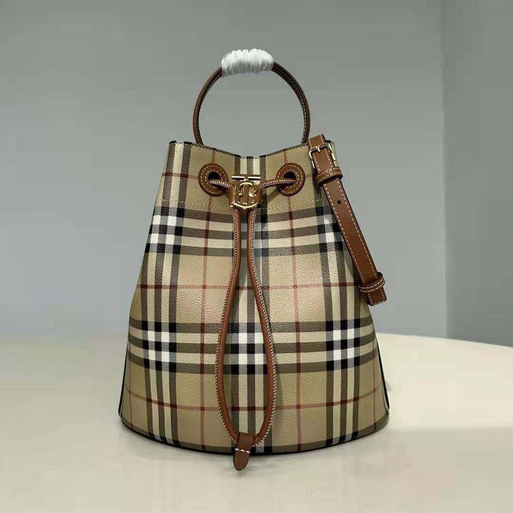 Side angle showing adjustable strap on Burberry Women Small TB Bucket Bag-Brown
