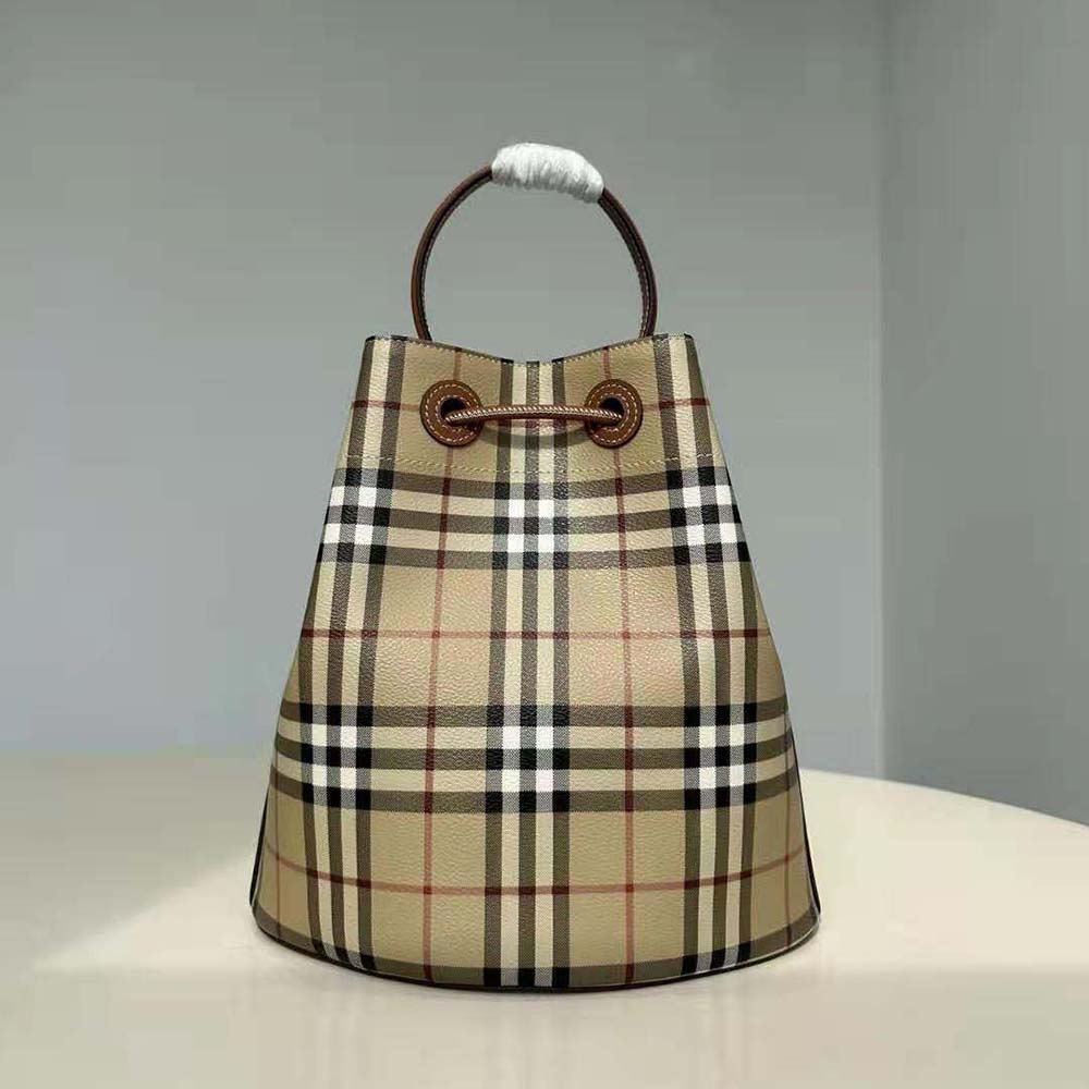 Close-up of antique gold TB hardware on Burberry Women Small TB Bucket Bag-Brown