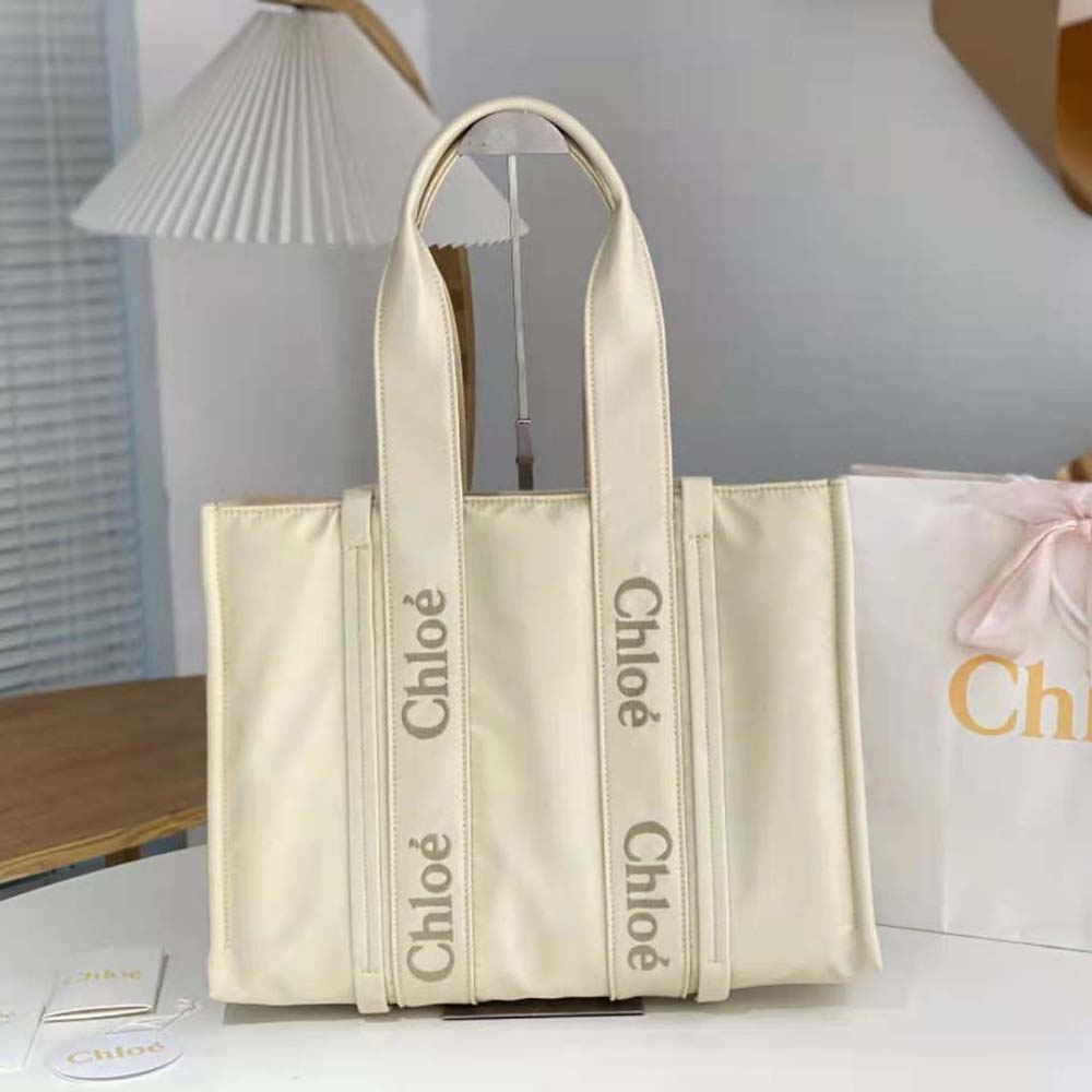 Close-up detail of braided leather handles on Chloe Large Woody Tote
