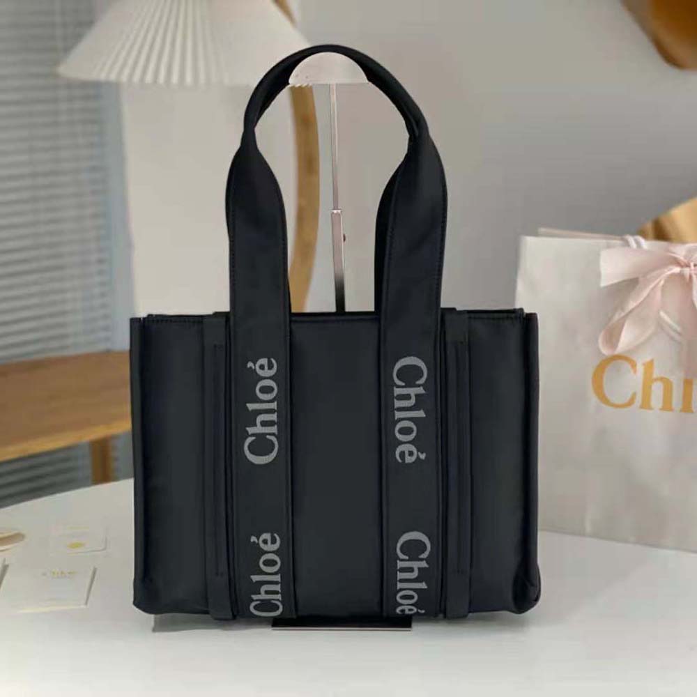 Side angle detail of gold-tone hardware on Chloe Women Medium Woody Tote Bag-Black