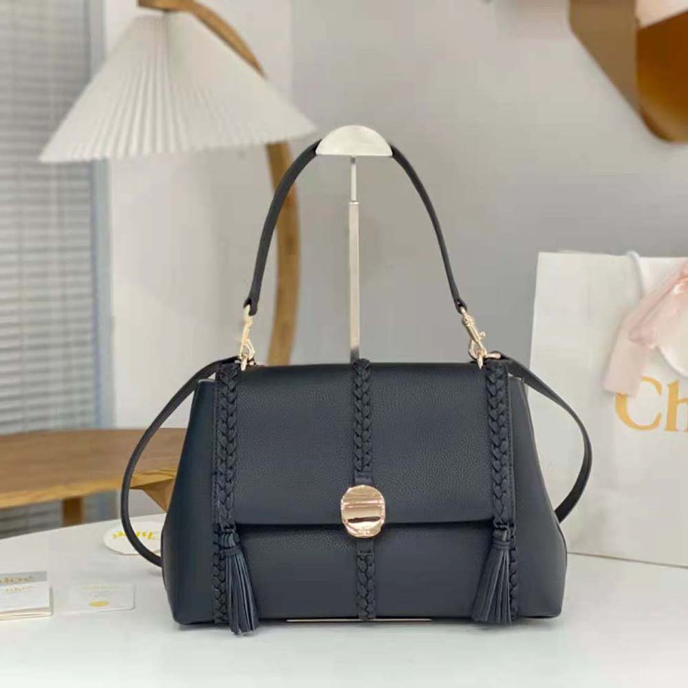 Close-up of gold-tone turn-lock closure on Chloe Women Penelope Medium Soft Shoulder Bag-Black