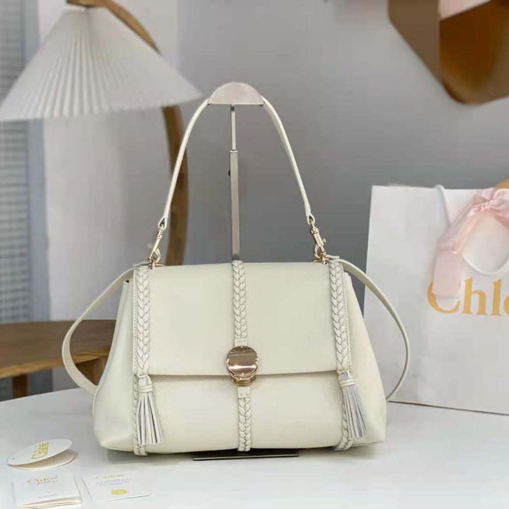 Close-up of gold-tone hardware on Chloe Women Penelope Medium Soft Shoulder Bag-White