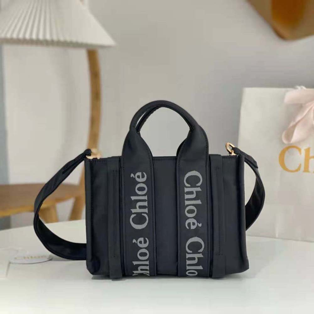 Close-up of woody top handle and gold hardware on Chloe Tote Bag Black