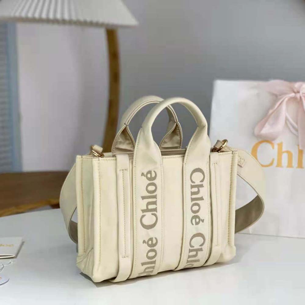 Side angle showing compact silhouette of Chloe Women Small Woody Tote Bag-White