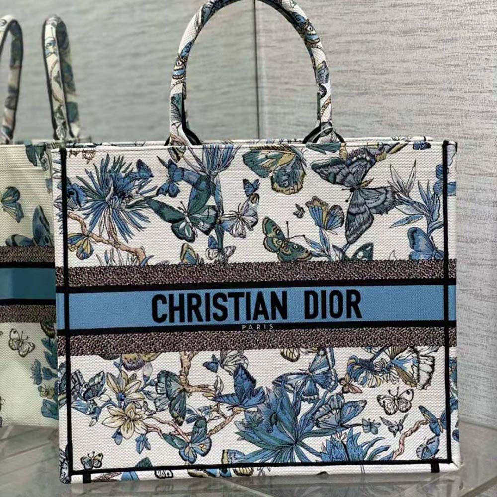 Close-up on pastel midnight blue embroidery on Dior tote canvas