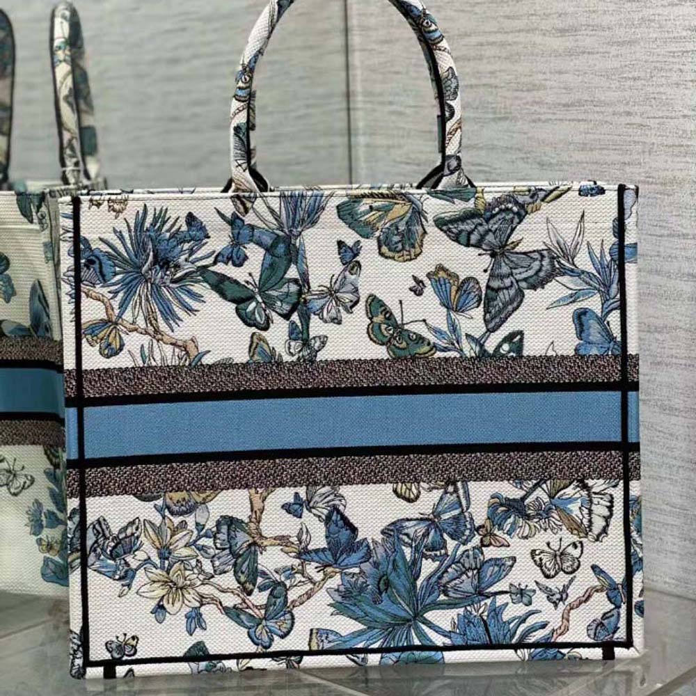 Side angle showing large silhouette and handles of Dior tote