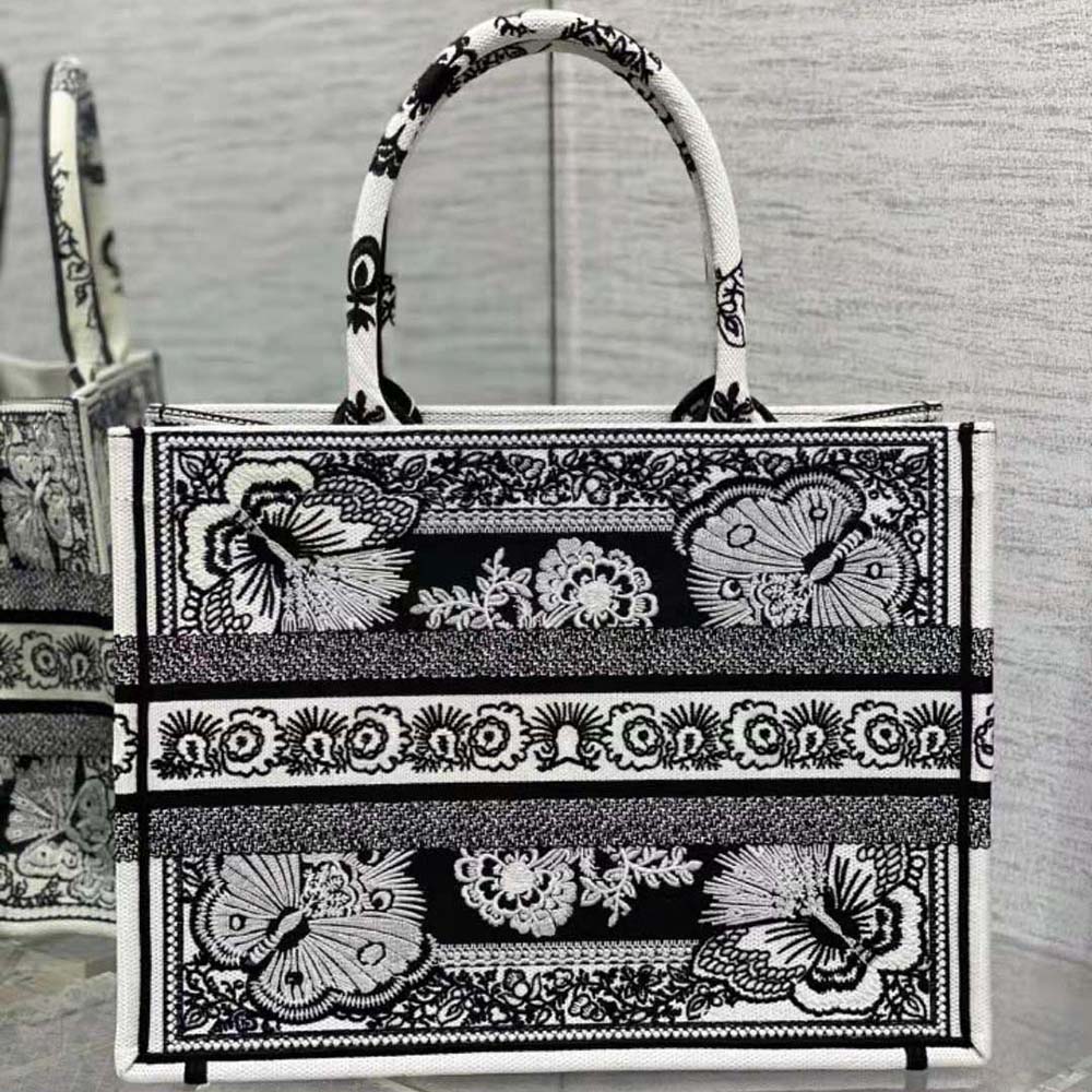 Side angle showing silver hardware and leather trims on Dior Book Tote