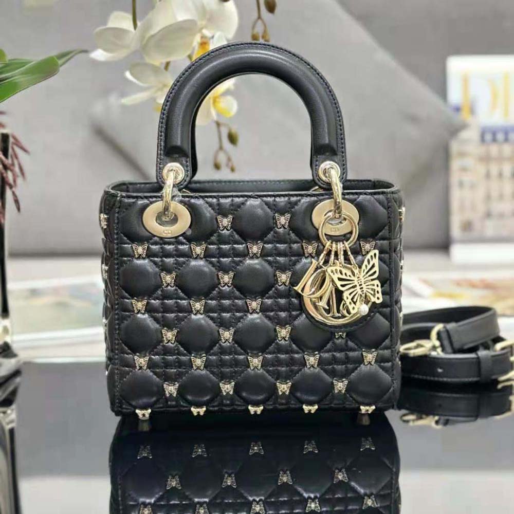 Close-up detail of gold butterfly studs on Dior Women Small Lady Dior Bag Black Cannage Lambskin