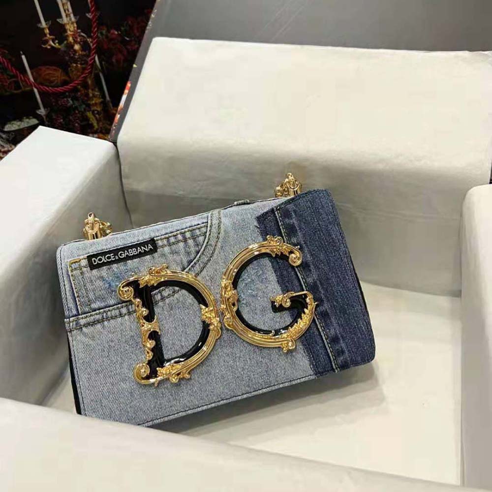 Close-up of gold-tone D&G logo hardware on denim and calfskin bag
