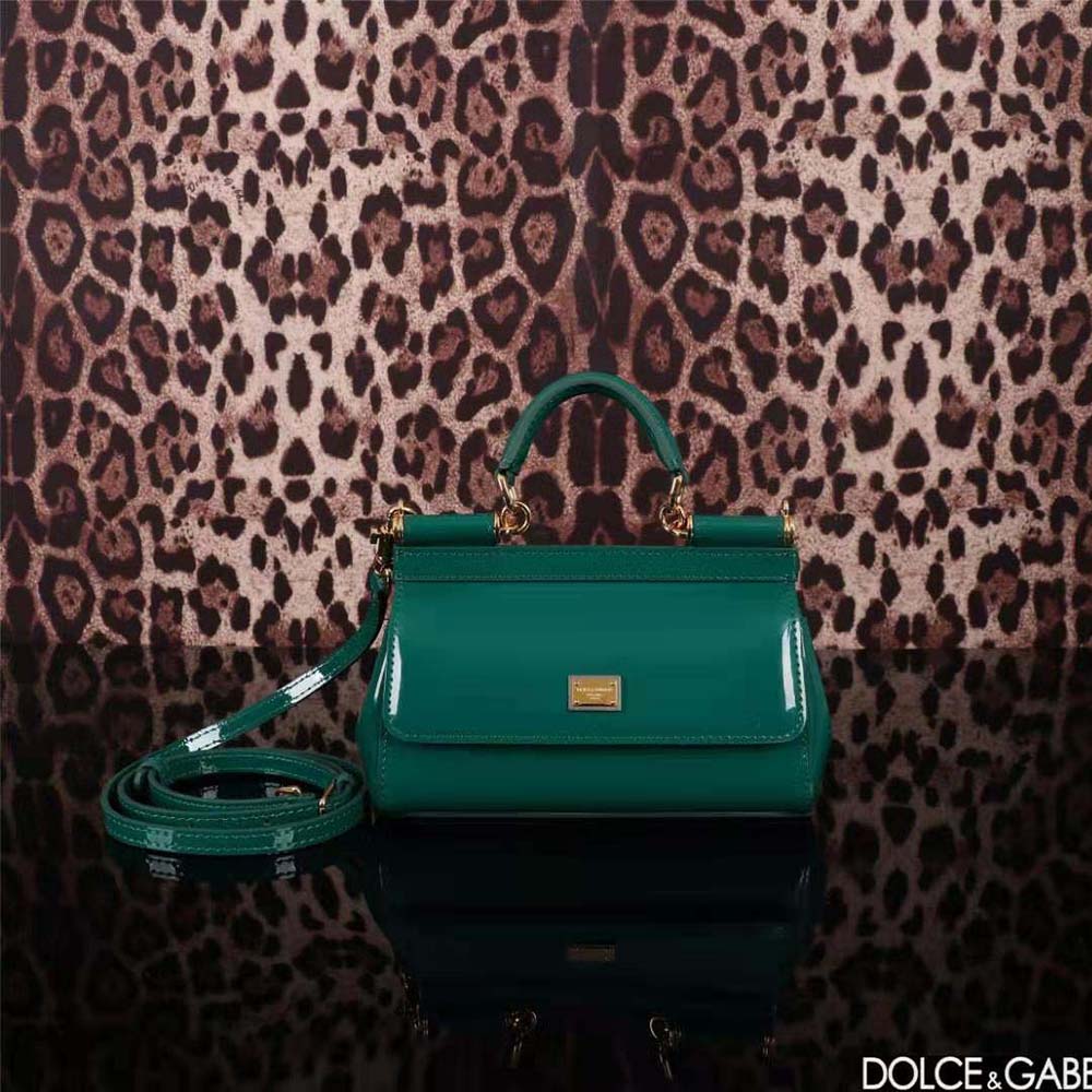 Close-up of green leather and signature gold closure on Dolce Gabbana D&G handbag