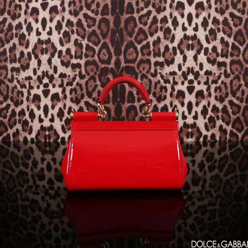 Close-up of the gold-tone D&G logo clasp on the red Small Sicily Handbag