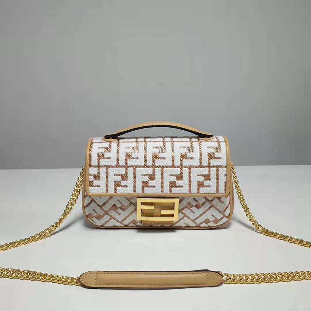 Close-up of gold-tone chain and white tapestry FF logo on Fendi raffia bag