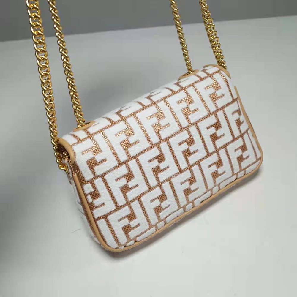 Side angle showing midi baguette silhouette and raffia texture of Fendi bag