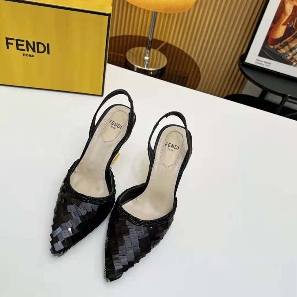 Close-up on black sequins and gold Fendi logo hardware detail
