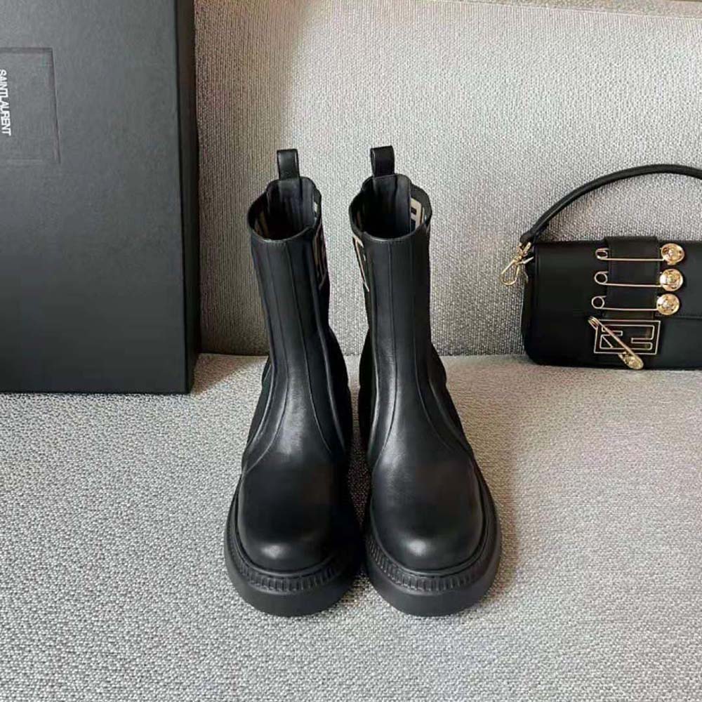 Close-up of Fendi metal hardware on black leather biker boots