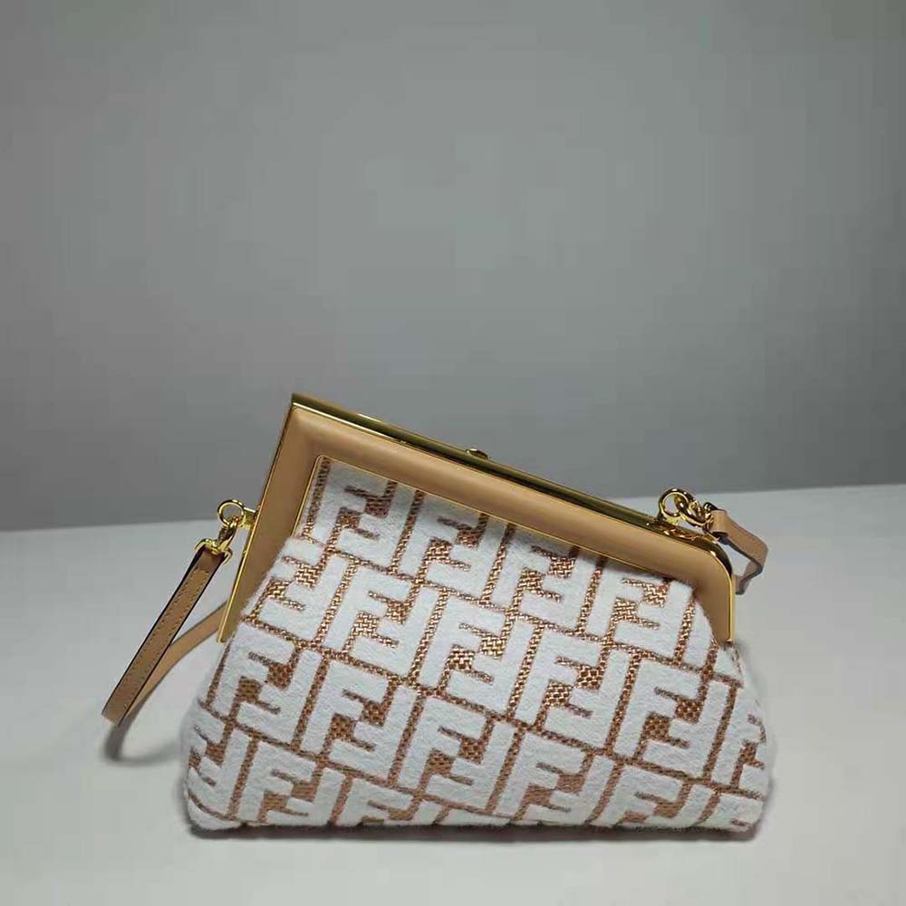 Side angle showing beige raffia texture on Fendi Women First Small Bag