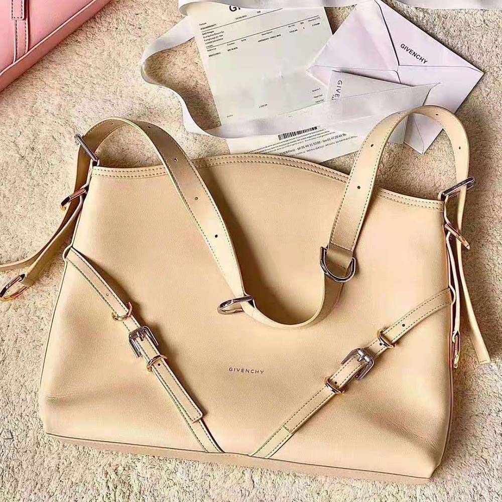 Close-up detail of beige leather texture and magnetic flap closure on Givenchy Voyou Bag
