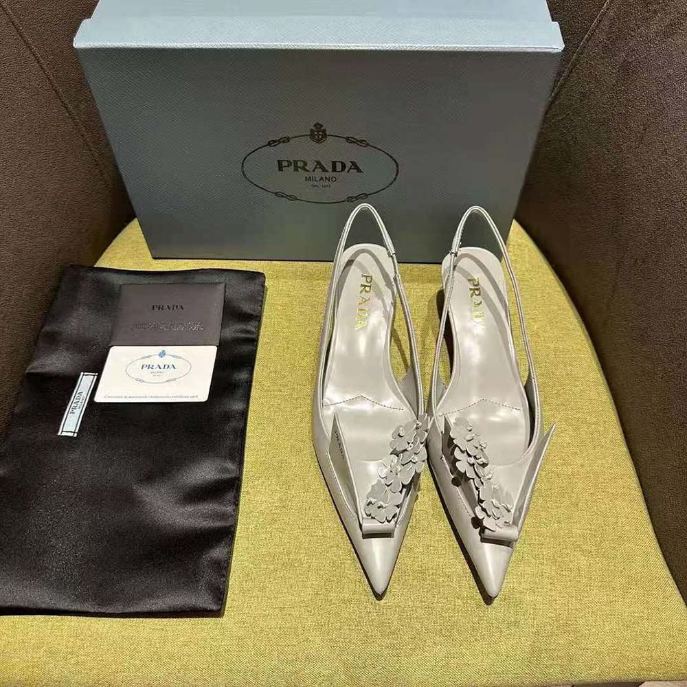 Close-up of gray brushed leather and floral appliques detail on Prada pumps
