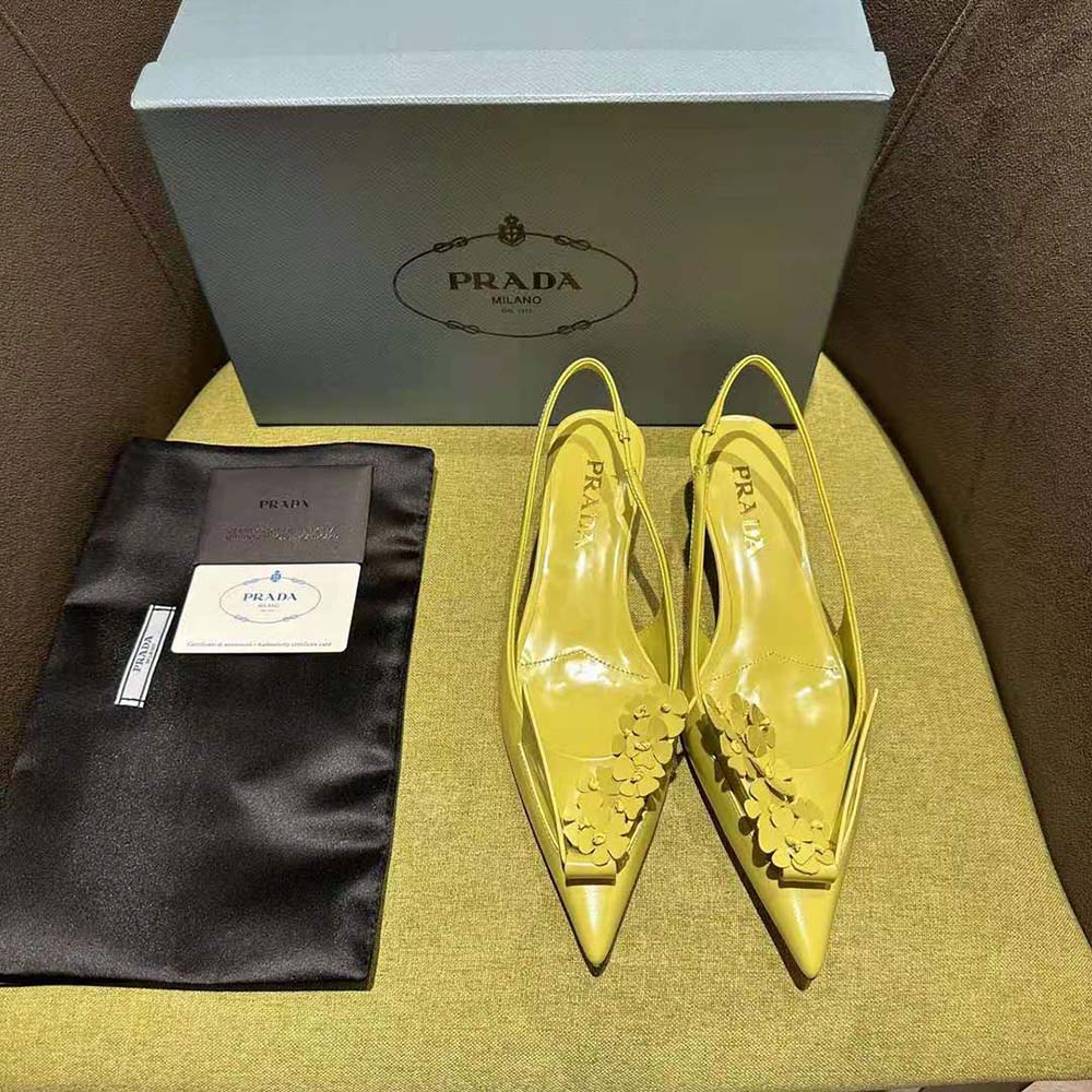 Close-up of floral appliques on Prada yellow brushed leather slingback pumps