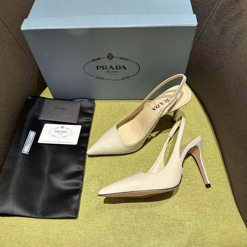 Close-up on adjustable buckle and Prada logo on White slingbacks