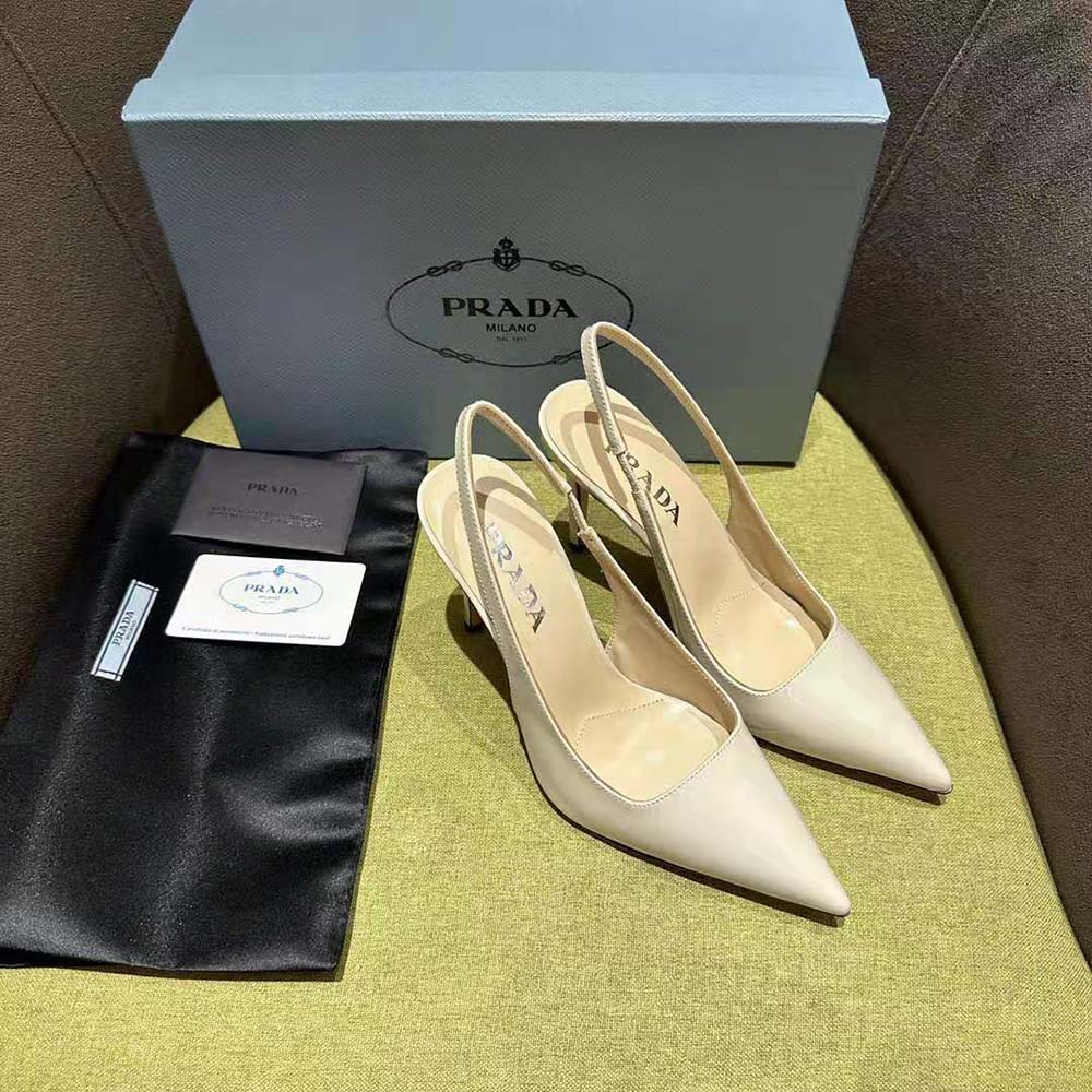 Angled front view highlighting pointed toe of Prada Women Patent Leather Slingbacks-White