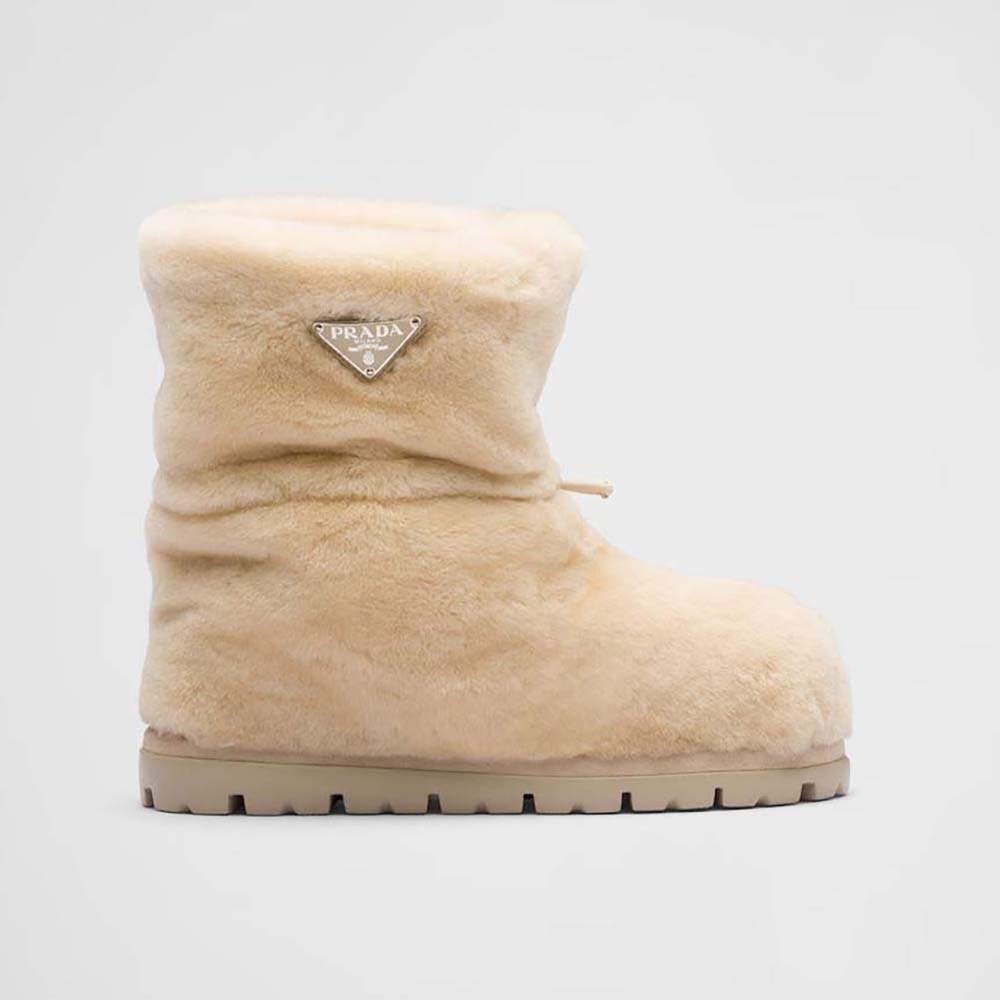 Side view of Prada Women Shearling Booties with Enameled Metal Triangle Logo-Beige