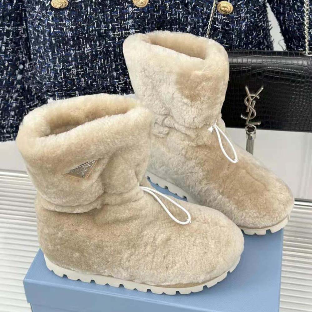 Top angle showing plush shearling lining of Prada Women Shearling Booties beige