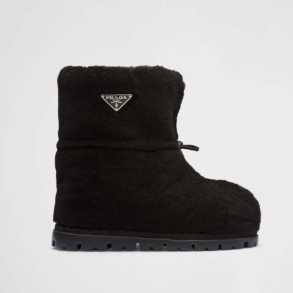 Side profile of Prada Women Shearling Booties with Enameled Metal Triangle Logo-Black