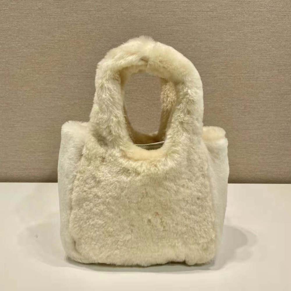 Side angle displaying compact silhouette of Prada Shearling Mini Handbag-Beige
