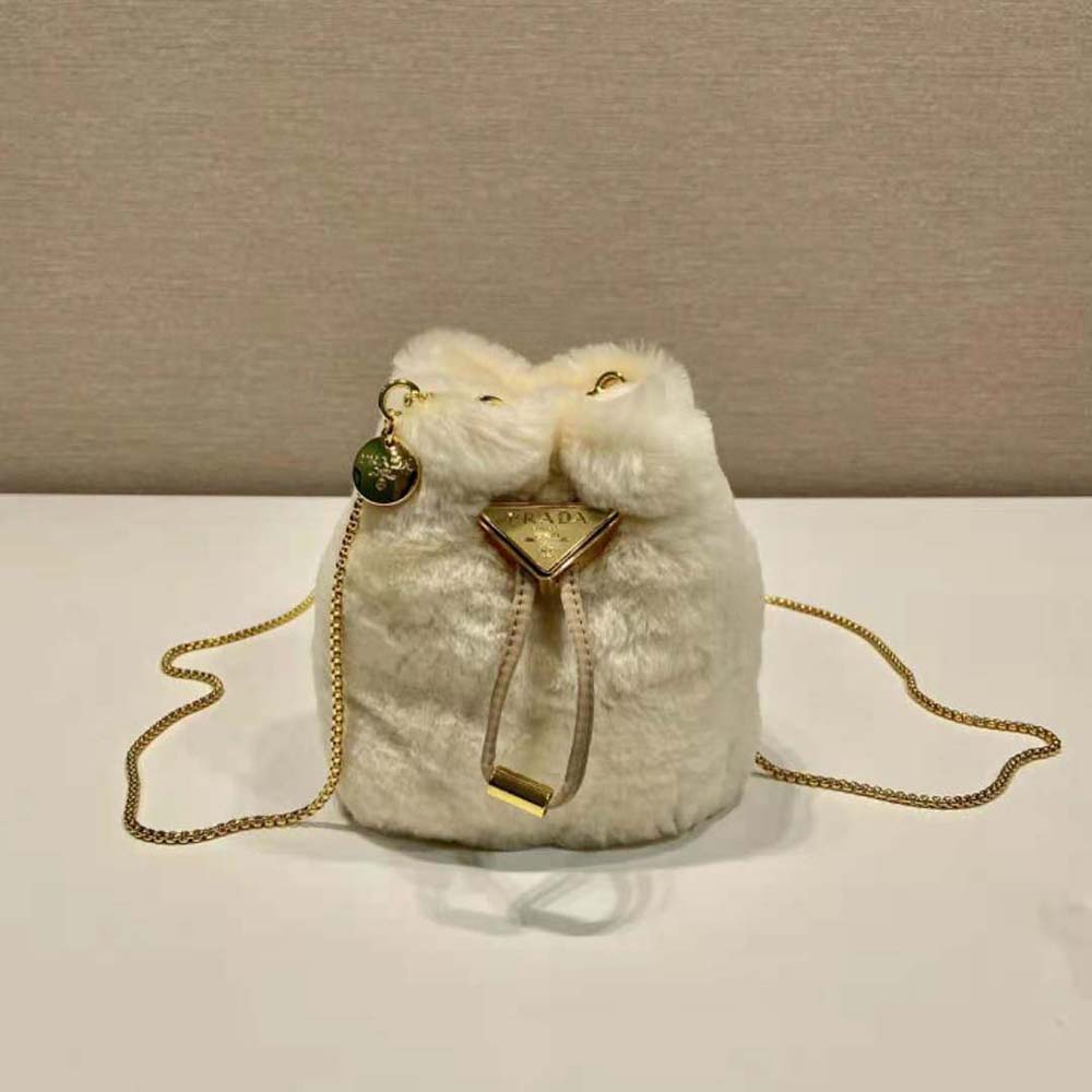 Close-up detail of plush shearling and Prada logo on mini-pouch