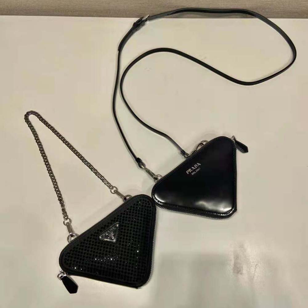 Side angle showing satin texture and leather trim of Prada triangular mini-pouch