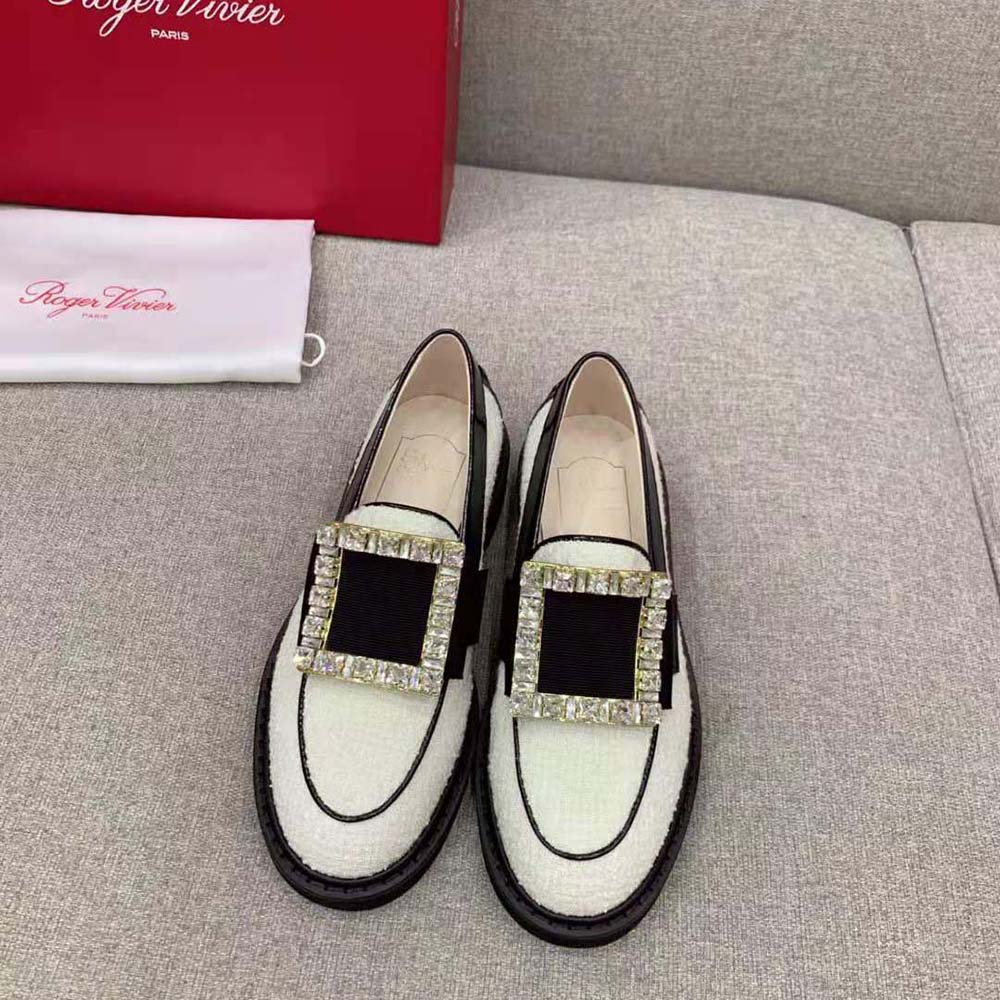 Close-up of white fabric and strass buckle on Roger Vivier loafers