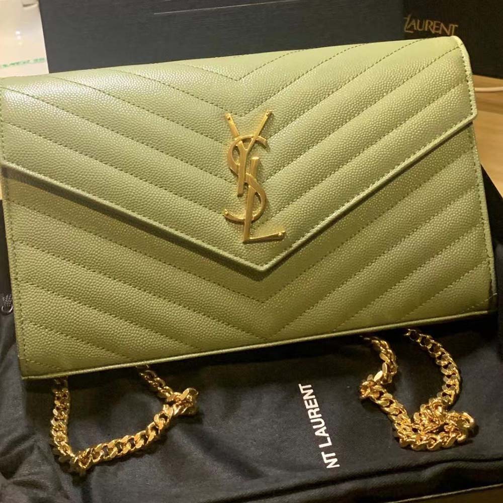 Side angle showing texture and chain strap of Saint Laurent Wallet in green